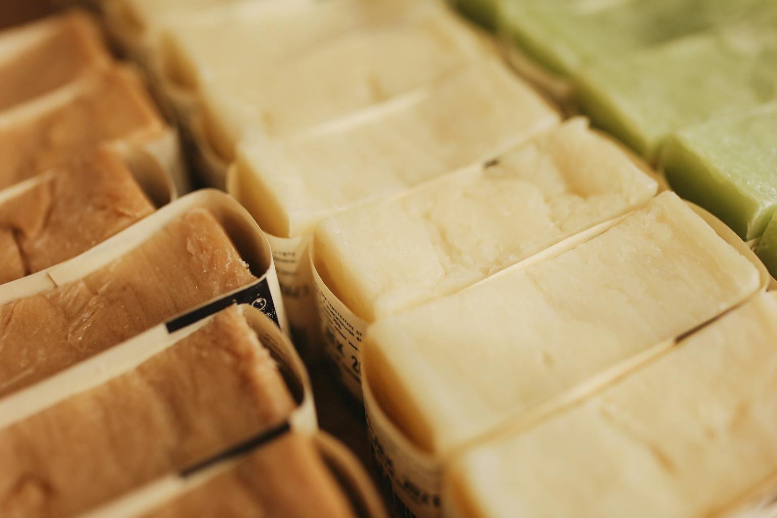 A variety of handmade natural bar soaps displayed in an organized manner, perfect for skincare and eco-friendly beauty products.
