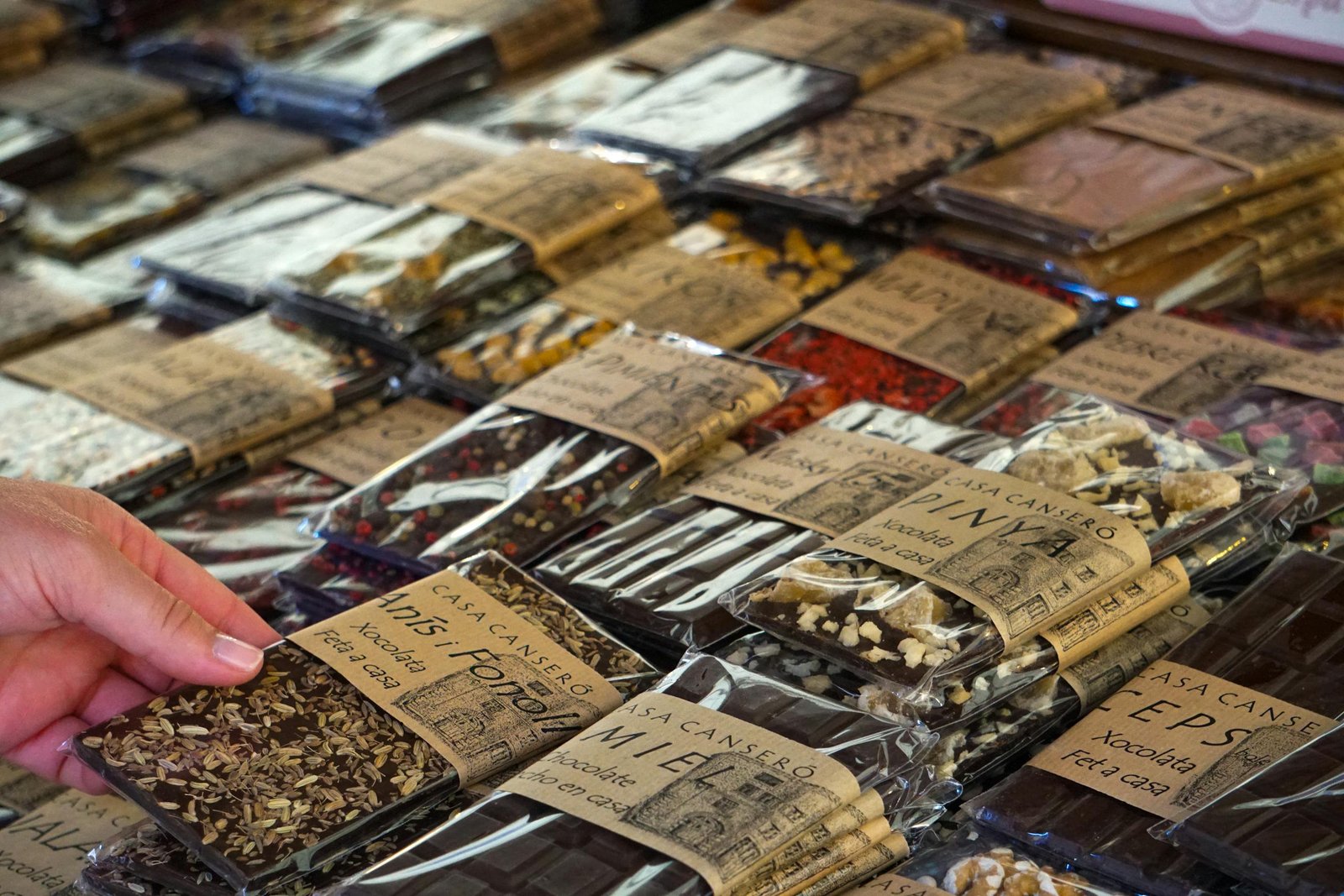 Close-up of artisan chocolate bars selection in a Spanish market. Perfect for gourmet product features.